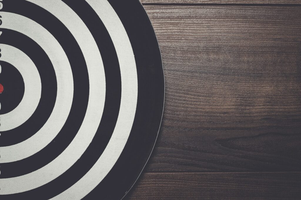 darts target on dark wooden background