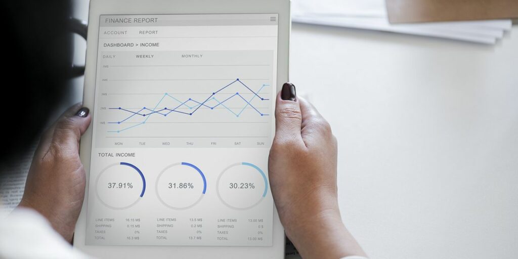 woman holding a tablet looking at finance