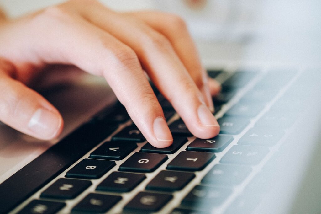 hand typing on laptop