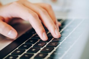 hand typing on laptop