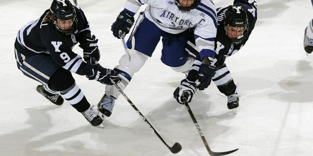 men playing ice hockey
