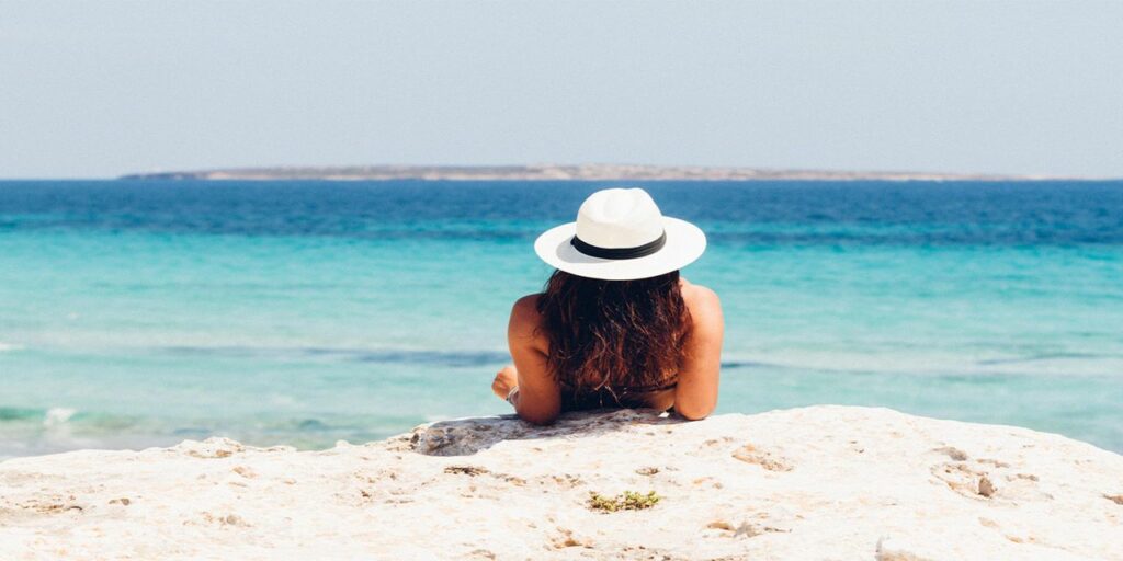 woman lying on the sand travel vacation