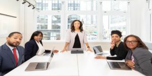 staffing woman standing on the center table with four people